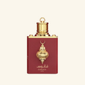 Fanoos perfume bottle in deep red with ornate gold metal detailing and a gold cap, centered on a light cream background.