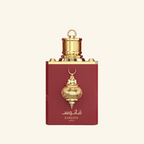 Fanoos perfume bottle in deep red with ornate gold metal detailing and a gold cap, centered on a light cream background.